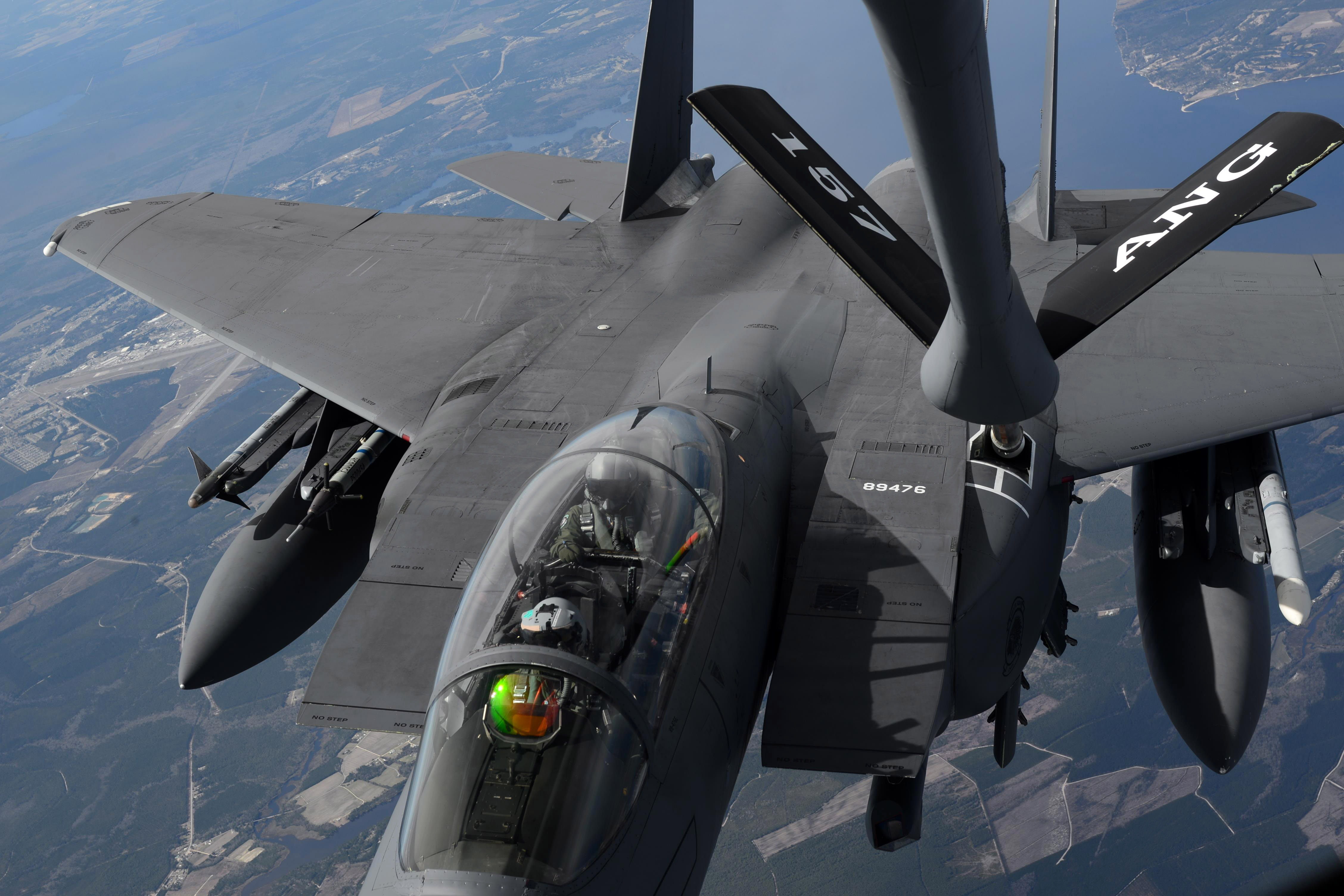 F-15E Strike Eagle — two-seat cockpit with pilot and WSO visible during aerial refueling